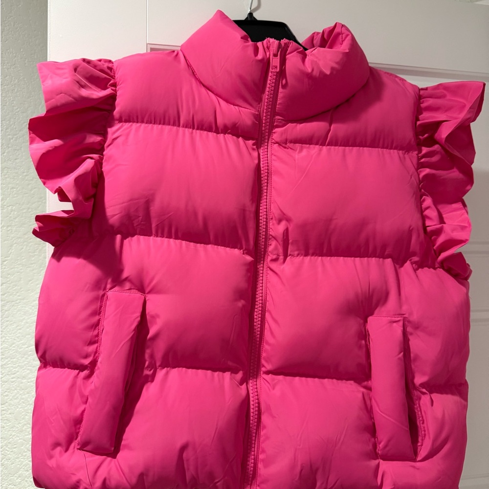 Large. Hot pink, puffer vest with ruffles. Never used.
